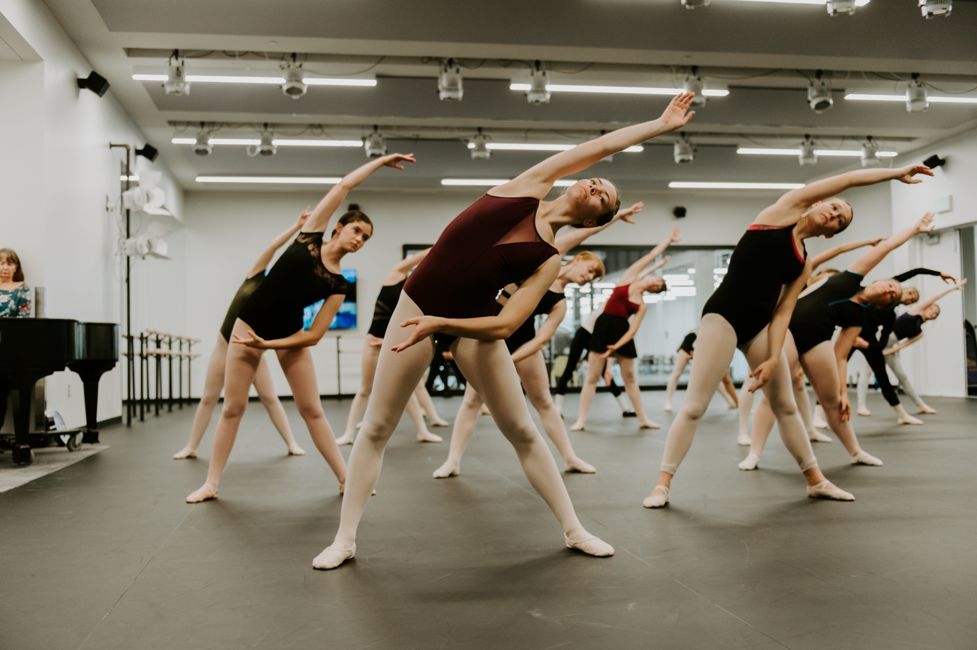 Young dancers stretching in a dance master class.