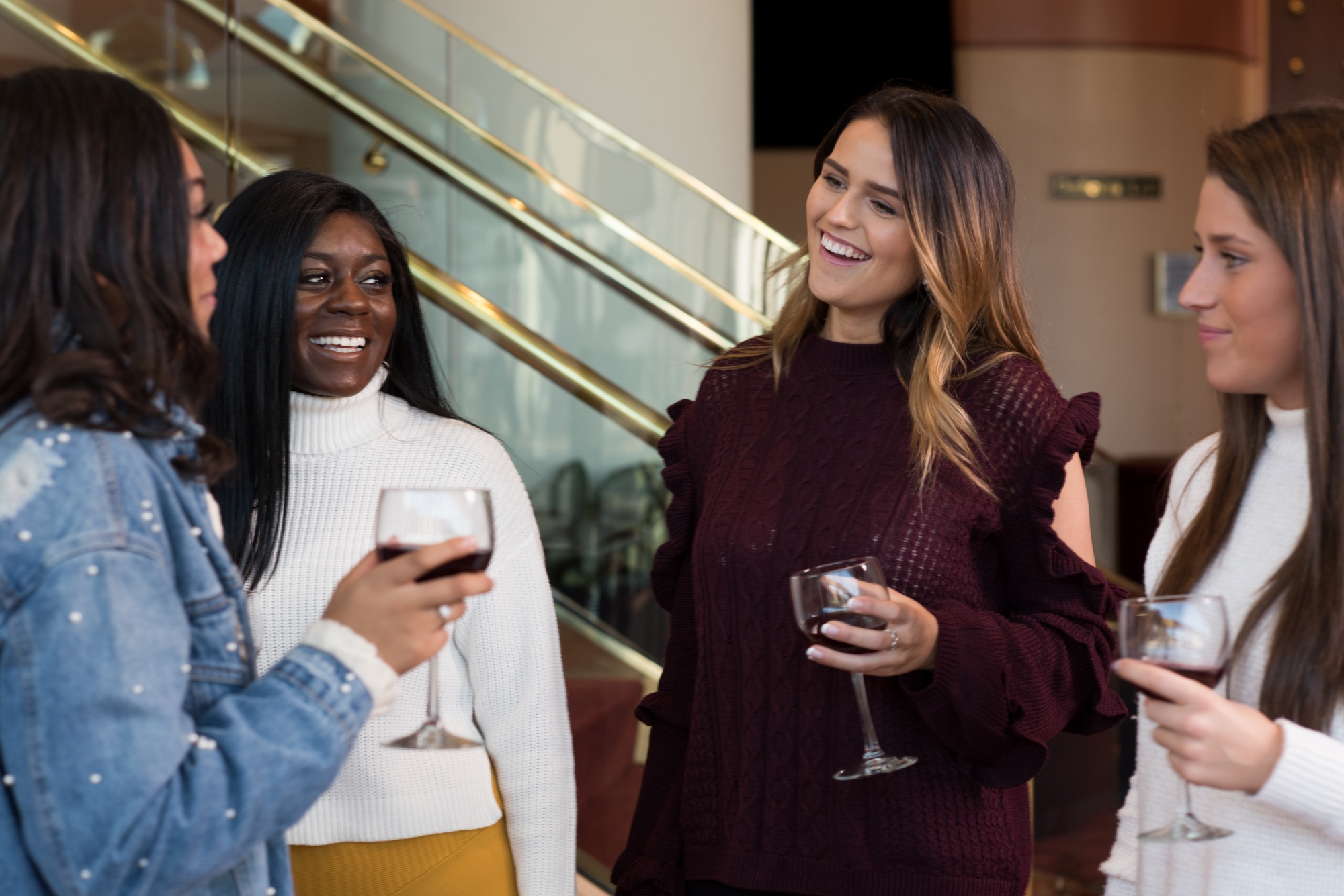 Image of a group of people laughing and enjoying drinks