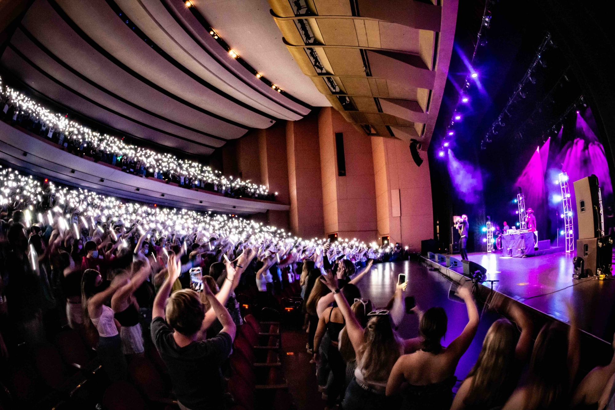 photo of a concert crowd in the lied center holding their phones with flashlights