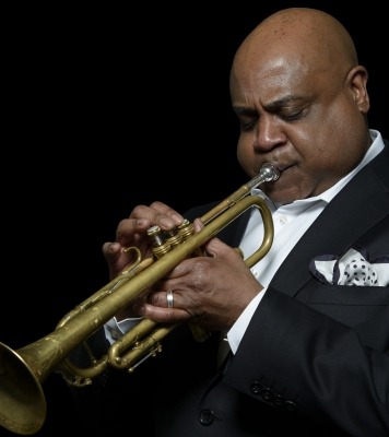 a man in a suit plays the trumpet