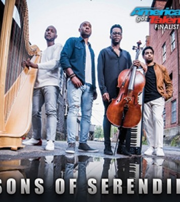 Four men, three holding instruments, standing outside