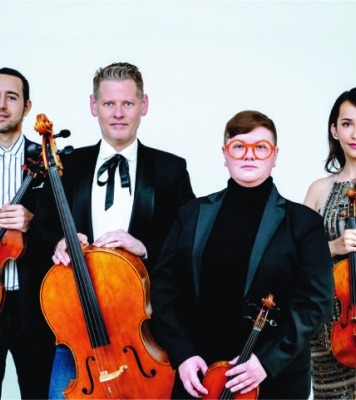 a quartet of string musicians pose together in fancy attire