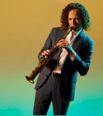 a curly haired man plays a woodwind instrument against a yellow and green gradient background