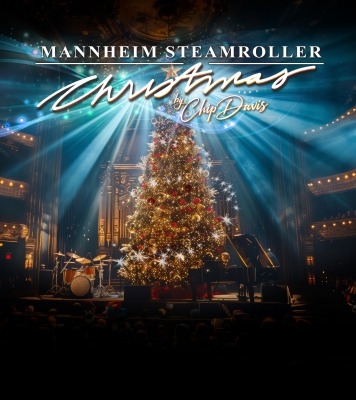 A sparkling Christmas tree sits center stage with beams of light and the show title at the top