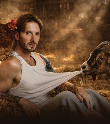 a man poses in front of a farm scene with animals