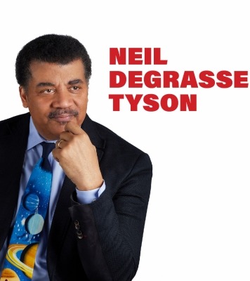 Dark skinned man with a black suit jacket and colorful tie with his face resting on his hand.