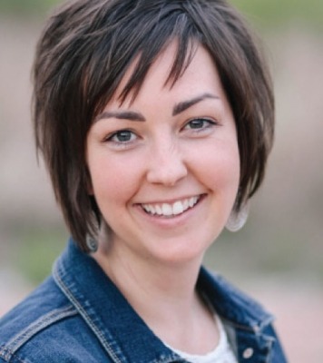 a smiling woman with short hair is living her best life in denim