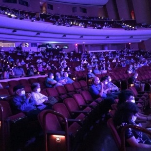 A socially-distanced audience fills the Lied Center.