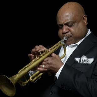 a man in a suit plays the trumpet