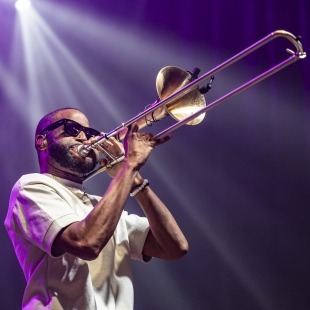man playing the trombone in sunglasses