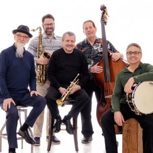 five men in suits pose together with their jazz ensemble instruments