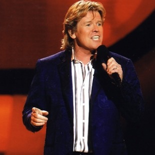 A man singing into a microphone