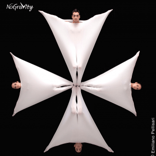 four people wrapped in fabric arranged in a geometric way