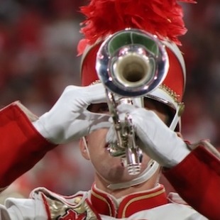 a unl student plays the trumpet in marching band uniform