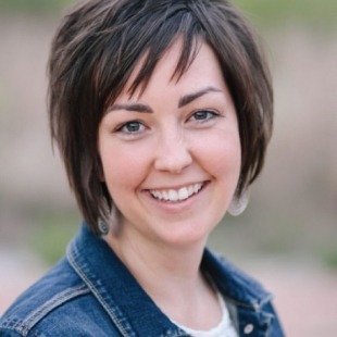 a smiling woman with short hair is living her best life in denim