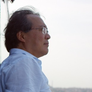 man with glasses looks off into the distance