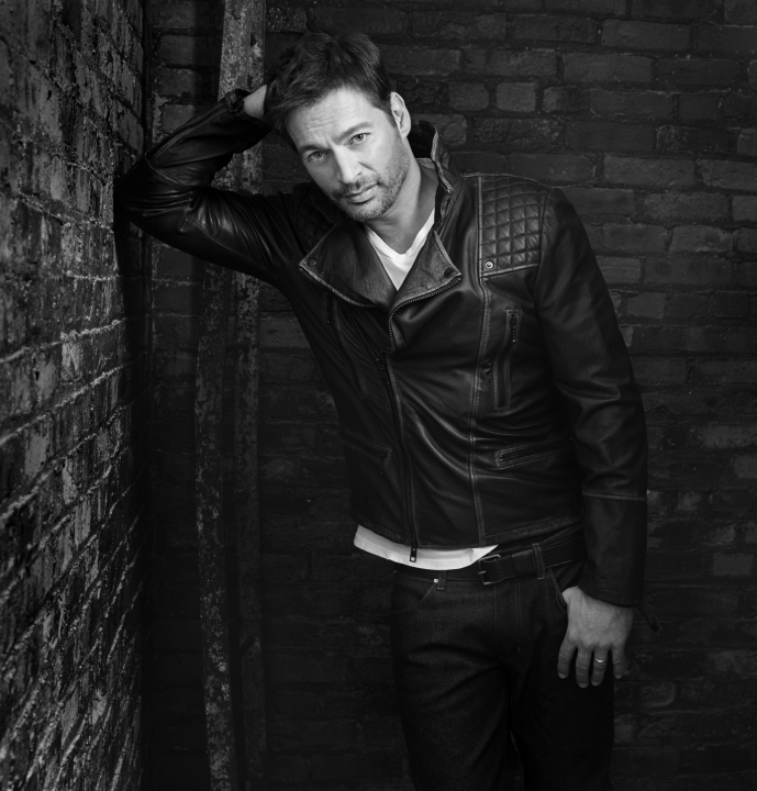 Black and white photo of Harry Connick Jr wearing a black leather jacket