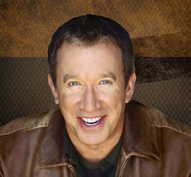 Head shot of Tim Allen wearing a brown leather jacket and smiling at the camera with a brown background