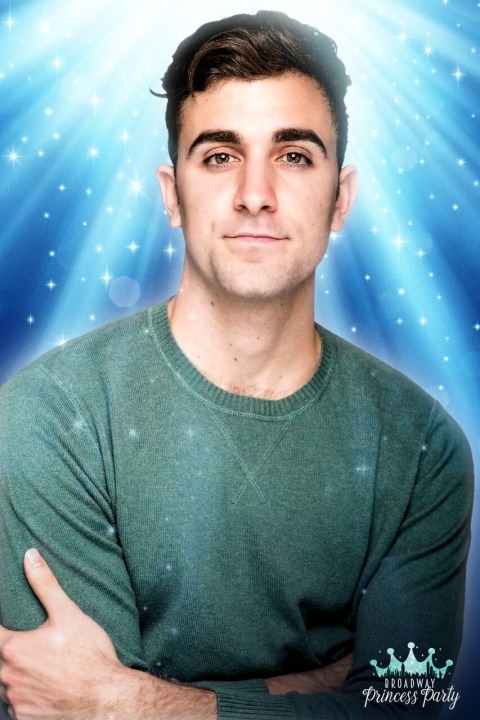 Adam Levy in a green shirt in front of a blue background