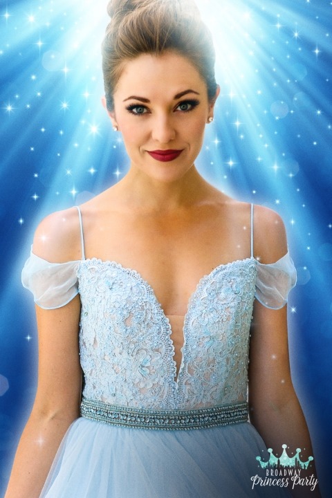 Laura Osnes in a light blue dress in front of a blue background