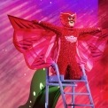 Image of PJ Mask's Owlette in a red costume, kneeling on a ladder with wings spread wide.