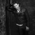 Black and white photo of Harry Connick Jr wearing a black leather jacket