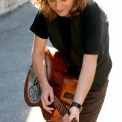 Susan Werner outside playing her guitar