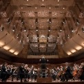 Image of Michael Tilson Thomas conducting the symphony on stage