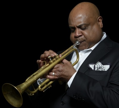 man in suit playing trumpet