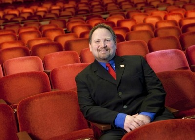 Image of Bill Stephan sitting in the iconic red seats of the Lied Center auditorium