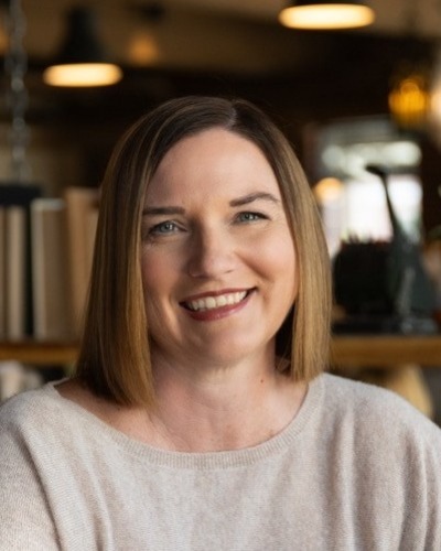 photo of clover Frederick, a woman with brown hair and a tan shirt