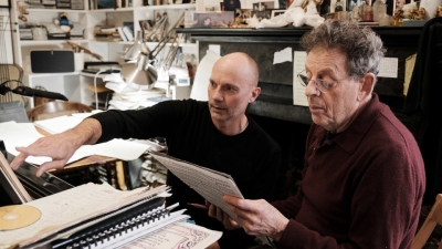 Image of Philip Glass and Paul Barnes collaborating at a piano