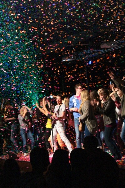 Image of the band OK Go with UNL students on stage