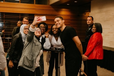 Image of Trevor Noah taking a selfie with fans