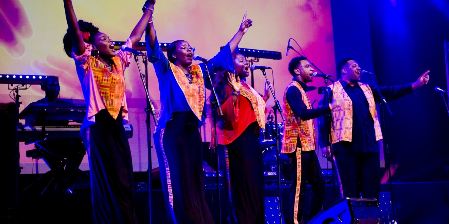 Image of five members of the Harlem Gospel Choir singing on stage in Nebraska with colorful outfits and arms raised