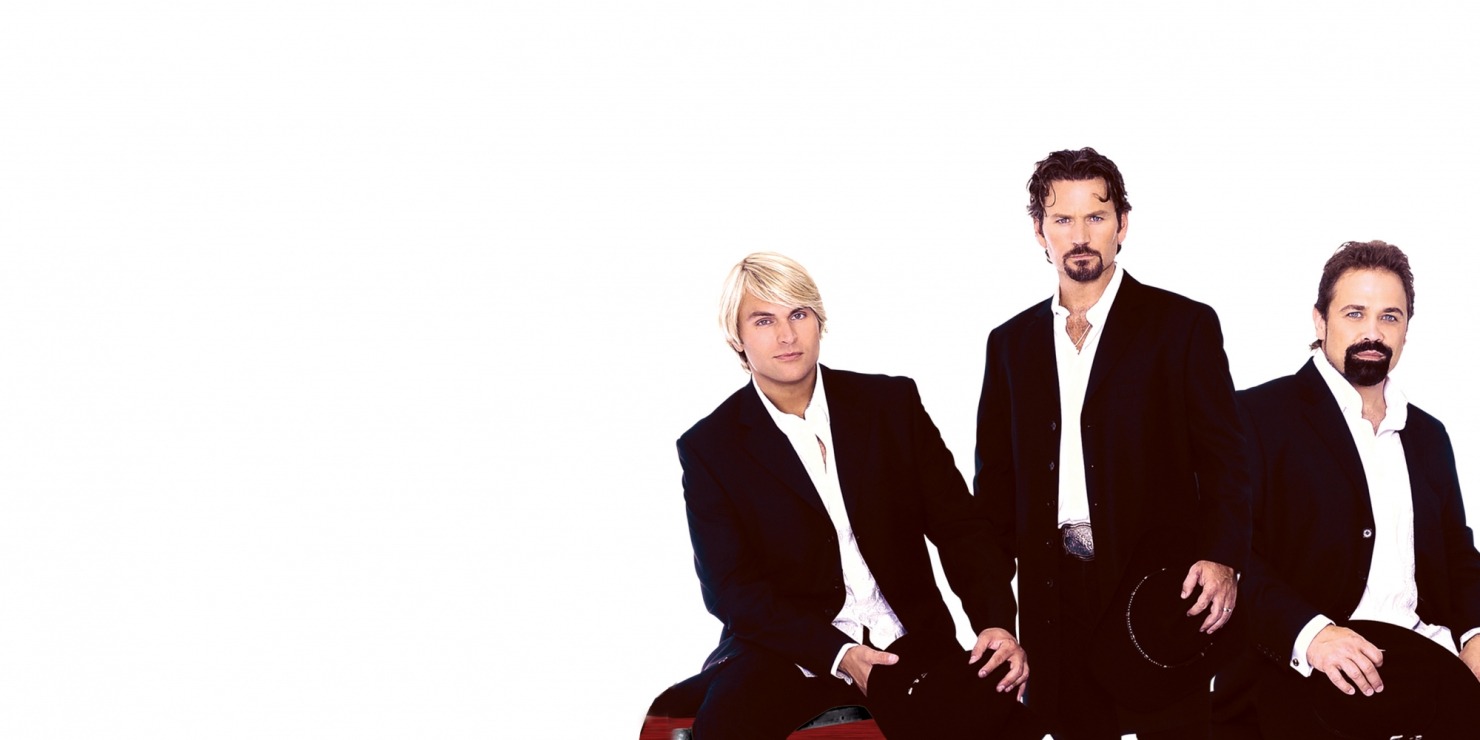 Three men in black suits and white shirts holding black hats in front of a white background.