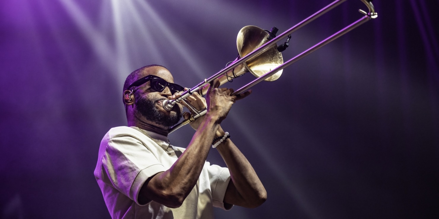 a man playing the trombone in sunglasses