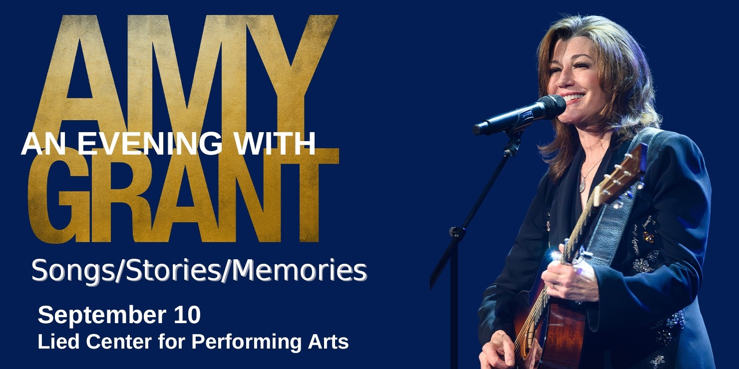 A woman with brown hair and a guitar singing into a microphone with "An Evening with Amy Grant" in gold and white letters