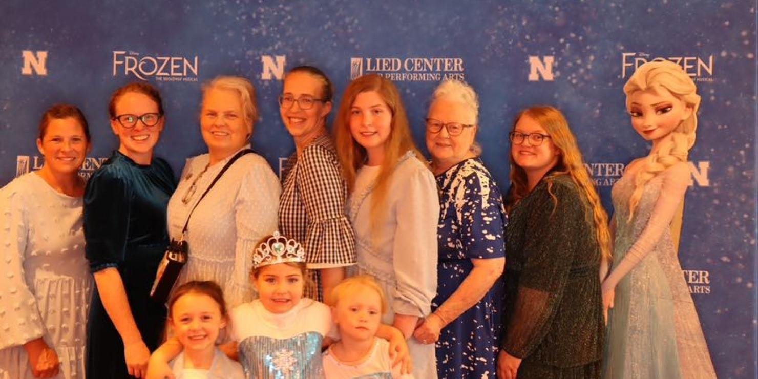 a group poses together in front of a backdrop