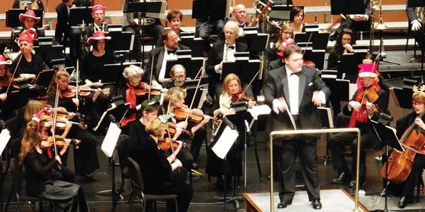 Lincoln's Symphony Orchestra plays their instruments dressed in Christmas costume