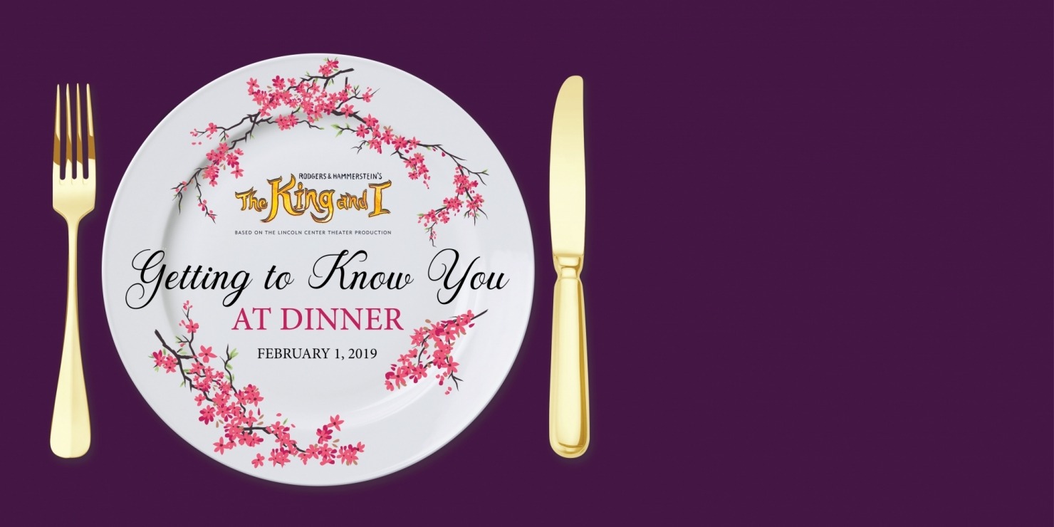 White plate with a purple background and golden fork and knife next to the plate. Cherry blossoms decorate the plate and the words "Getting to know you at dinner" are written on the plate.