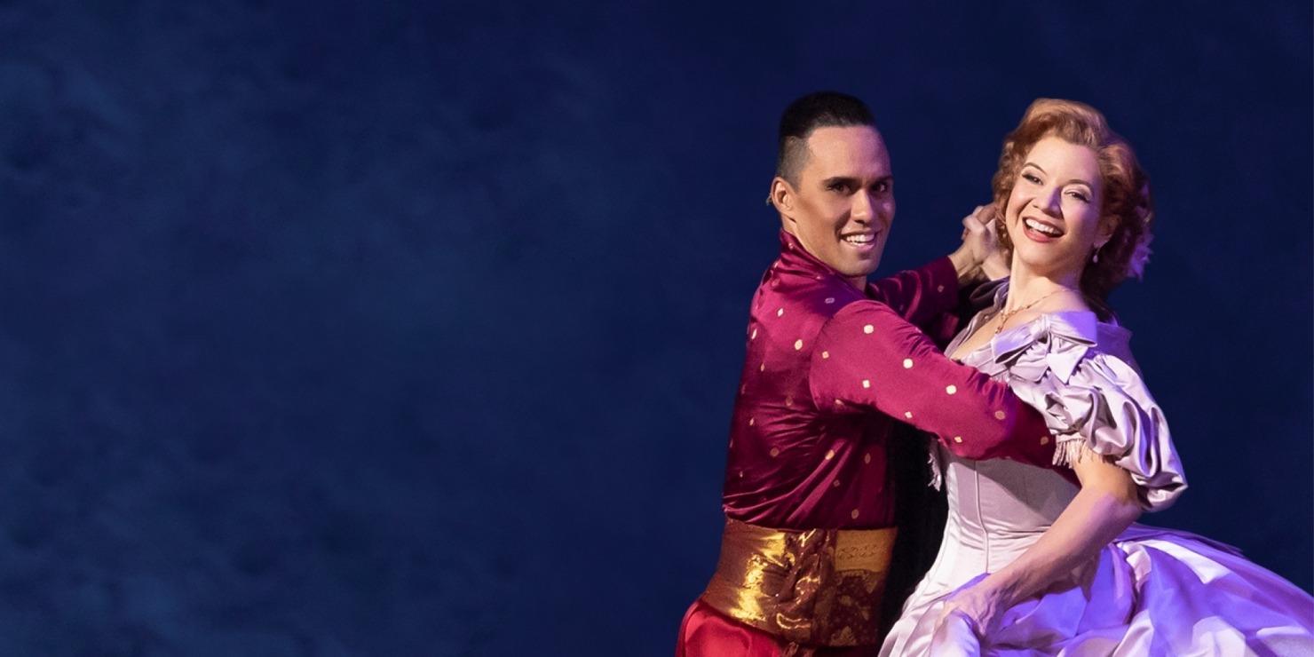 Man in red and woman in a pink ballgown dancing in front of a blue background.
