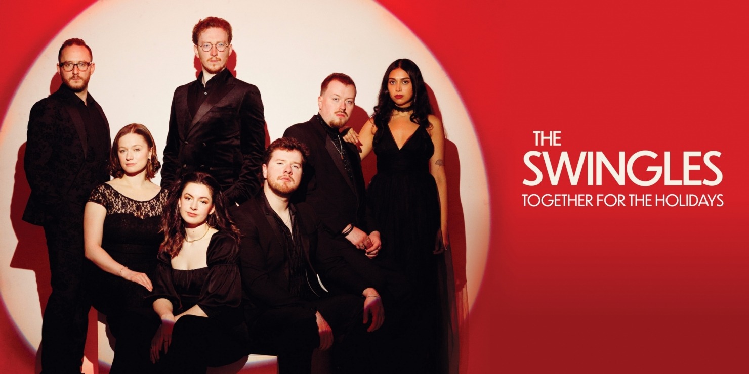 a group of seven smiling humans dressed in black pose closely together against a red background