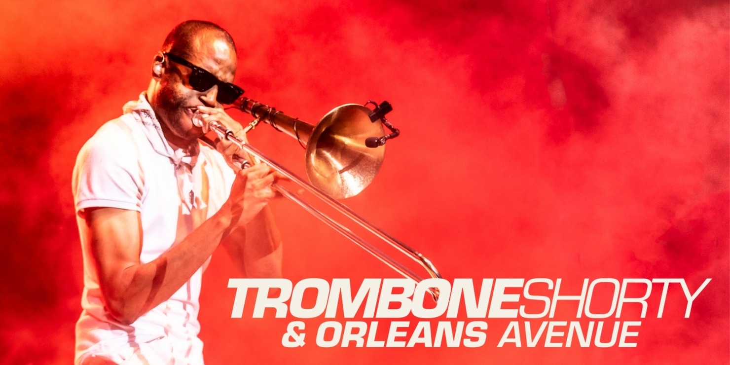 a man playing the trombone in sunglasses in red haze