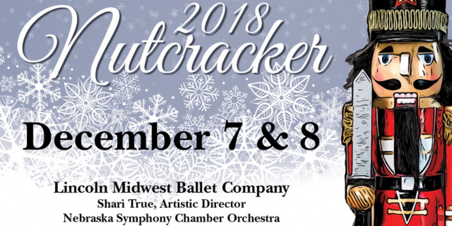 Nutcracker figurine in front of a grey-blue background with white snowflakes.