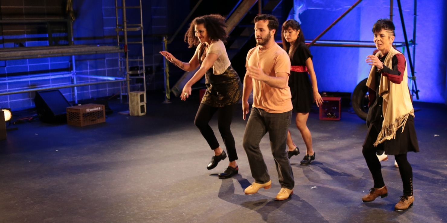 One man and three women all wearing brown, black, and red and all stepping with their right foot in front of a blue background.