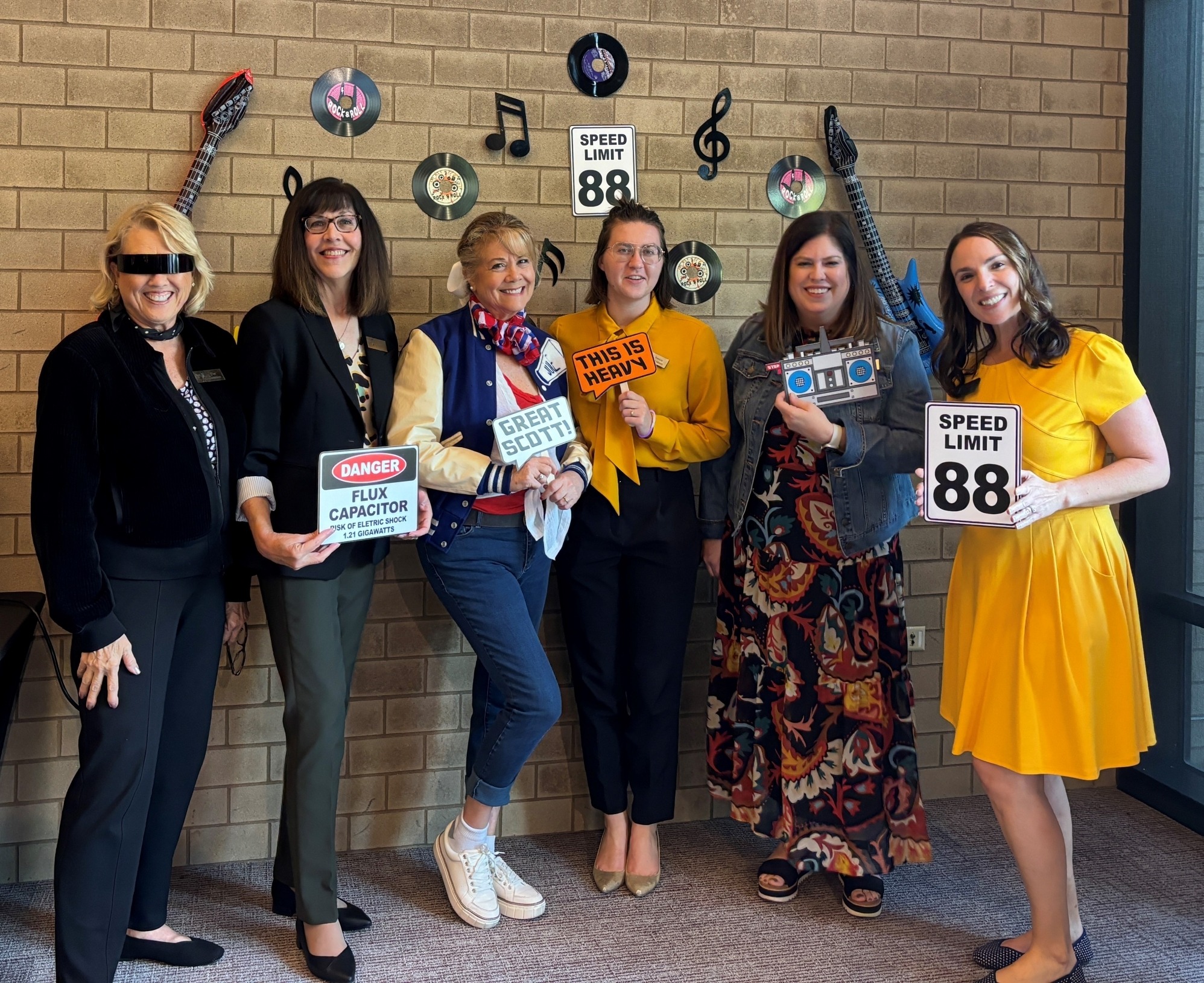 photo of a group of friends of lied members at a bright colored party 