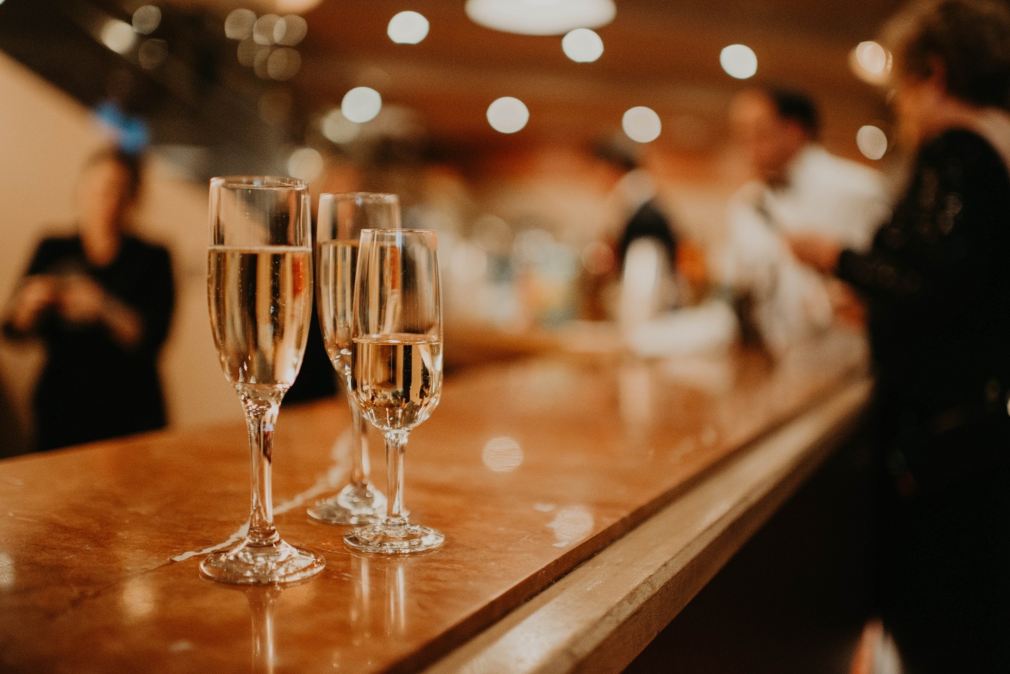 Image of three champagne flutes on the Lied Center bar