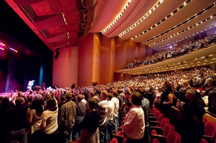 Image taken from the crowd of a full house for a Lied Center performance standing to applaud the performers