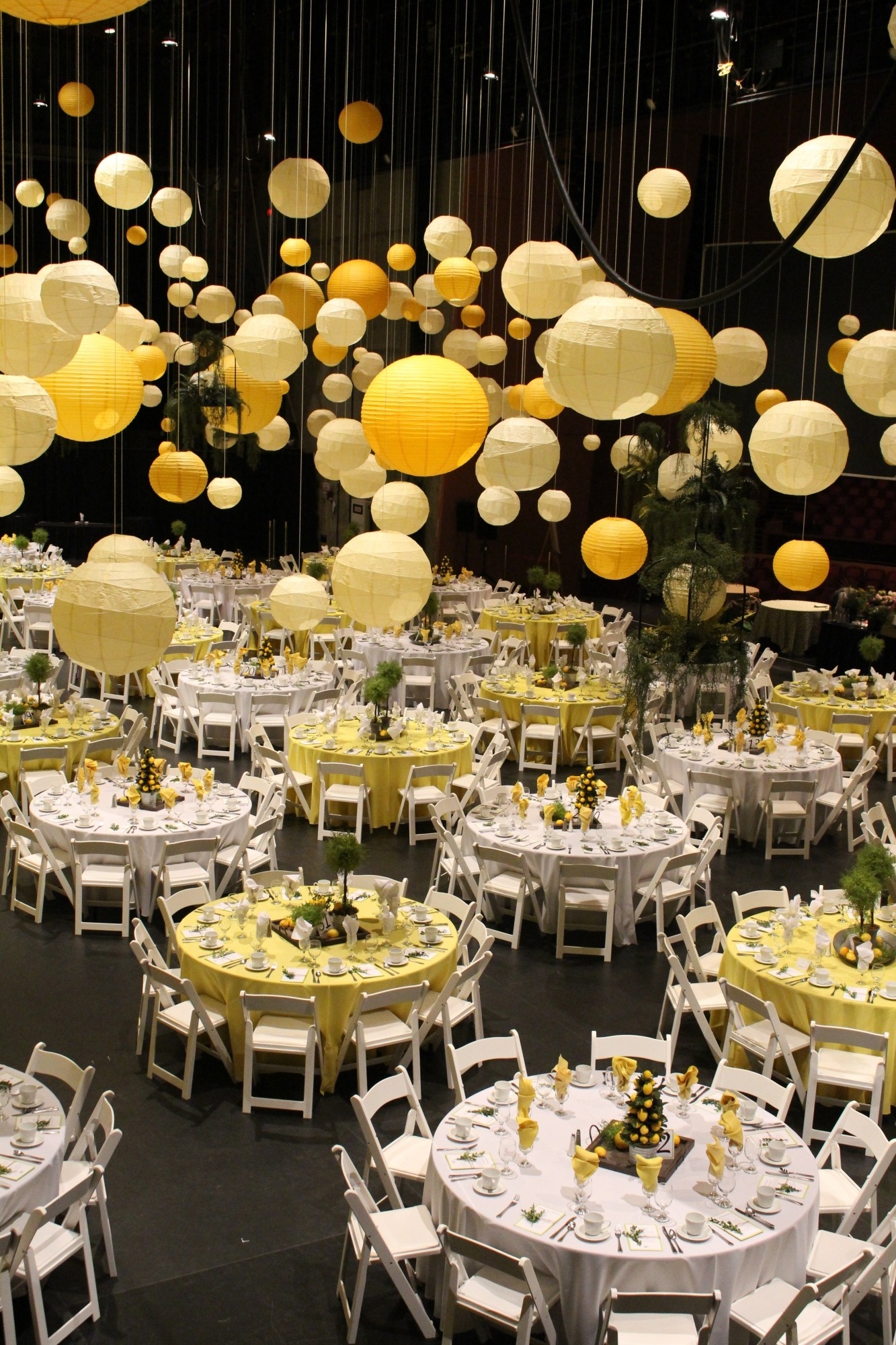 image of tables set up for a party with yellow balloons